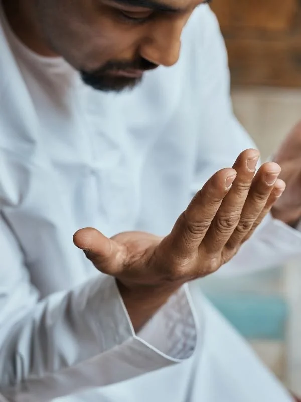 Believer in peaceful prayer in a quiet mosque seeking tranquility